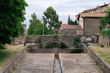 Fototapeta premium Old bridge in the village over the water channel
