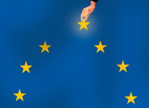 Hand picking star from European flag