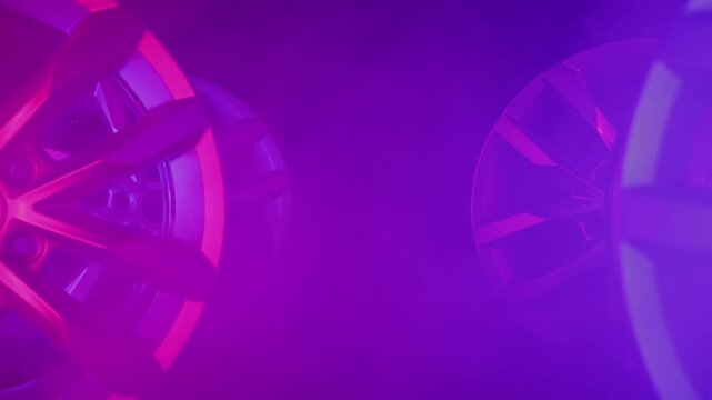 4 Bright aluminum alloy rims for car without tire. Smoke. Equipment for auto vehicle. Luxury design. Car spare parts isolated in dark background. RGB light. Wide shot, dolly in movement