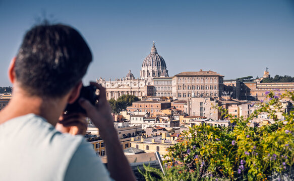 Man clicking picture of St. Peter's Basilica in Italy