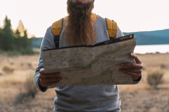 USA, North California, close-up of bearded man reading map on a hiking trip near Lassen Volcanic National Park