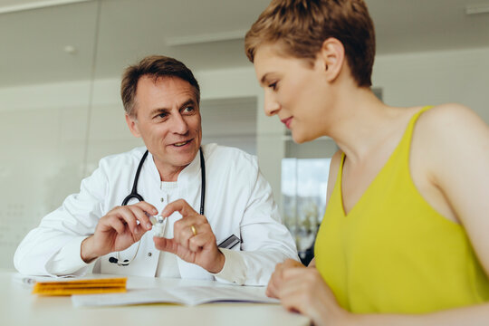 Woman discussing teatment with her doctor
