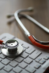 Stethoscope on Keyboard Symbolizing Telemedicine and Healthcare Technology Integration