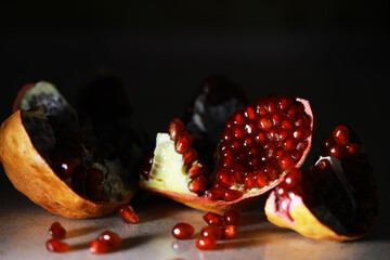 Close-Up of Fresh Pomegranate with Red Seeds on Dark Background