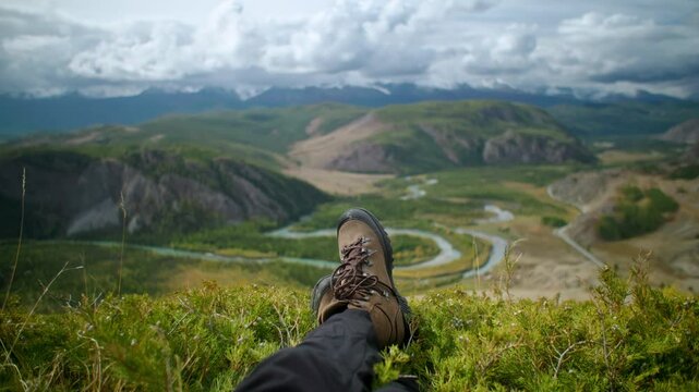 Close up boots travaler person enjoying the serene and breathtaking mountain views while relaxing on peaceful hike in the great outdoors