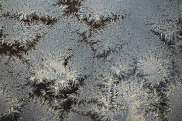 Close-Up of Delicate Frost Crystals Forming Intricate Patterns on a Cold Windowpane