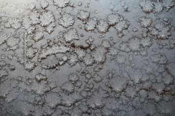 Close-Up of Frost Patterns on a Windowpane During Winter Morning