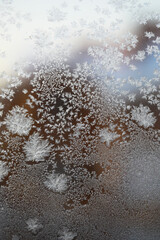 Intricate Ice Crystals on Frosted Window in Winter Season