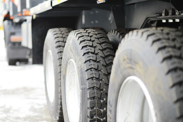 Close-Up of Heavy-Duty Truck Tires on Snowy Ground with Tread Patterns