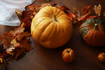 Autumn Pumpkins and Leaves on Wooden Table - Seasonal Harvest Decoration