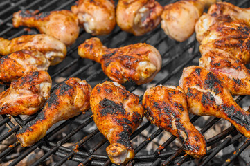 Spalone zwęglone niezdrowe mięso pałki z kurczaka leżą na grillu