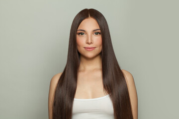 Pretty model woman with sleek long shiny brown hair. Cosmetology, hair and skin care, keratin...