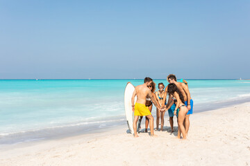Group of friends on the beach stacking hands