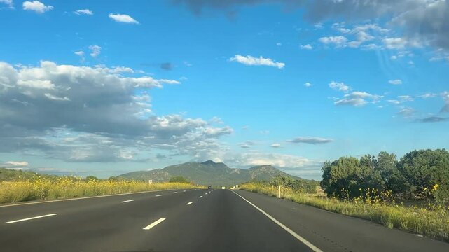 Driving down highway with blue skies