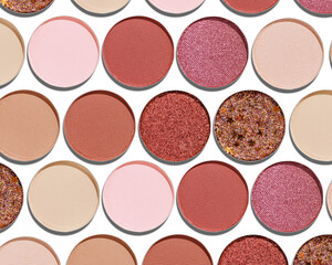 Colorful Swatches eyeshadow refills as minimal geometric pattern. Matte and glitter pans red brown pink shade with sun shadows, detail texture, cosmetic, beauty product, makeup, warm color scheme