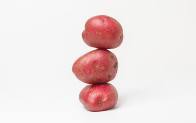 Stack of red potatoes on white background