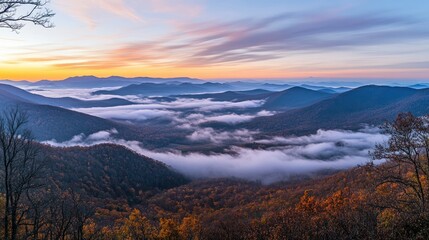 Mountain view with fog at sunrise.