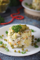 Olivier salad, traditional Russian dish, served on the plate	