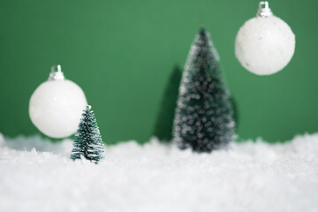 A white snow scene with a Christmas tree and ornaments on a green background. Xmas premium podium for advertising and presentation your product. Showcase, display case.