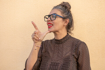 Woman Communicates Using Sign Language Against Textured Wall