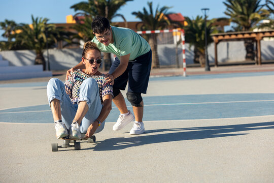 Down syndrome teenager enjoying outdoor sports with family