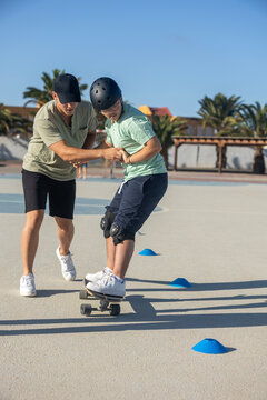 Down syndrome teenager skateboarding with family support