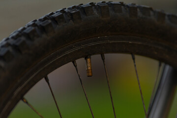 Here we see a closeup image of a bicycle tire that features a valve integrated into it, showcasing essential components clearly and distinctly