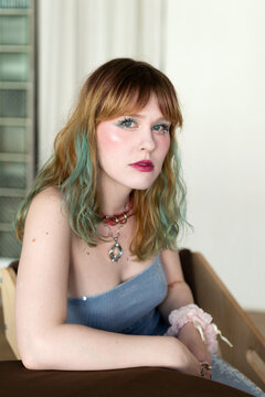 Woman with Colorful Hair and Pastel Makeup in Casual Setting