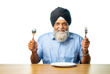 Elderly Sikh man enjoying a meal or empty plate, holding utensils and showing a happy perfect sign