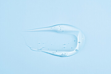 Textured smear of cosmetic cream on blue background