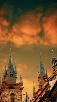 Close-up of the tower of the Church of Our Lady before Tyn at sunset. The spiers of the ancient European historical cathedral in Prague. Landmark against the sky.