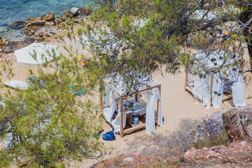 : Secluded Beach Scene With Wooden Cabanas And Blue Waters