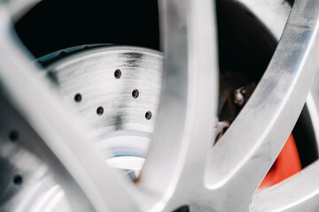 Shiny Drilled Brake Rotor on Car for High Performance Driving