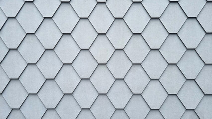 A section of a gray building facade made of hexagonal tiles
