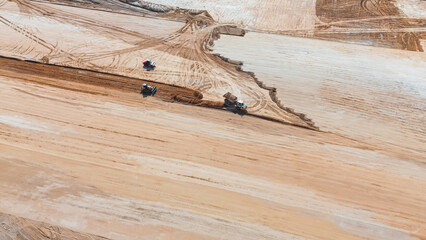 Construction vehicles leveling dirt area