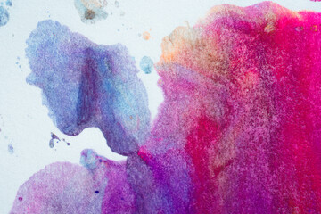 Multi-color paint swirls on paper white background