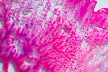 Pink paint drops and splotch on white background