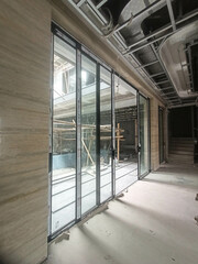 Jakarta, Indonesia - December 11, 2024: Large sliding glass doors are in a building under...