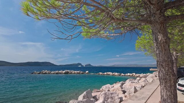 Distant Mediterranean Greek island coastal views from Pylos harbour waterfront