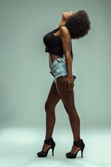Latin american model posing with afro hairstyle and high heels