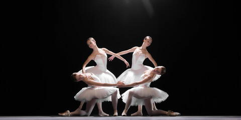 Tender and elegant pose. Four beautiful and artistic young girls, ballet dancers in white tutus...