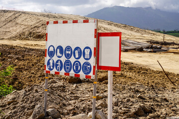 Construction Warning Sign and Empty Signboard on Site