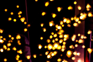 blurred Christmas background with included garlands on a Christmas tree
