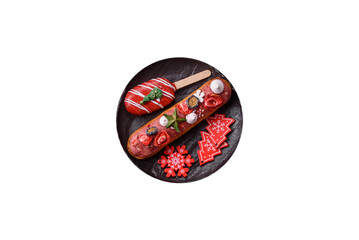 Sweet eclair with chocolate filling, decorated for Christmas