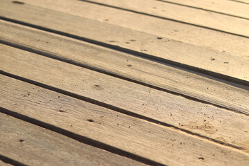 Wooden decking on the beach, close-up on the boards. Boardwalk. Background. Weathered wooden boards...