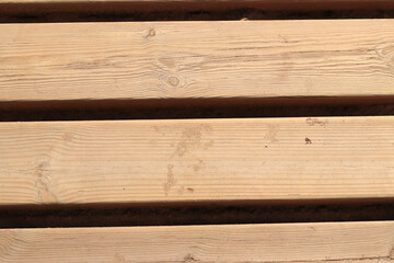 Wooden decking on the beach, close-up on the boards. Boardwalk. Background. Weathered wooden boards...