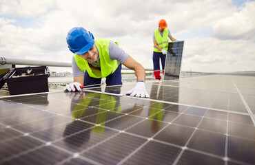 Team of happy male workers technician craftsmen or electrical engineers in uniform installing...
