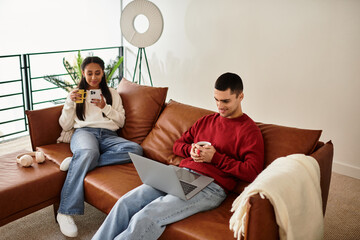 A beautiful couple enjoys warm drinks and love in their stylish winter attire at home.