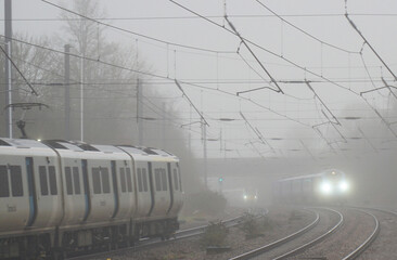 Three Train in mist and rain with lights