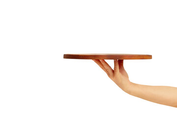 Man hand holding a brown round wooden tray on a blue background with copy space